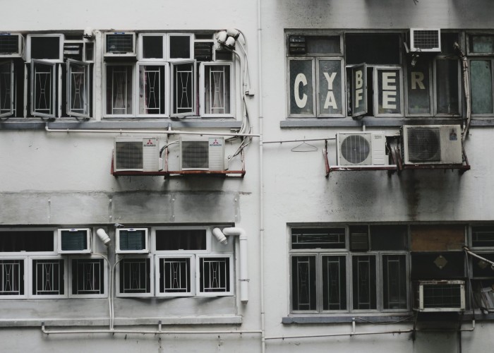 A Life2Life technician servicing an air-conditioning unit